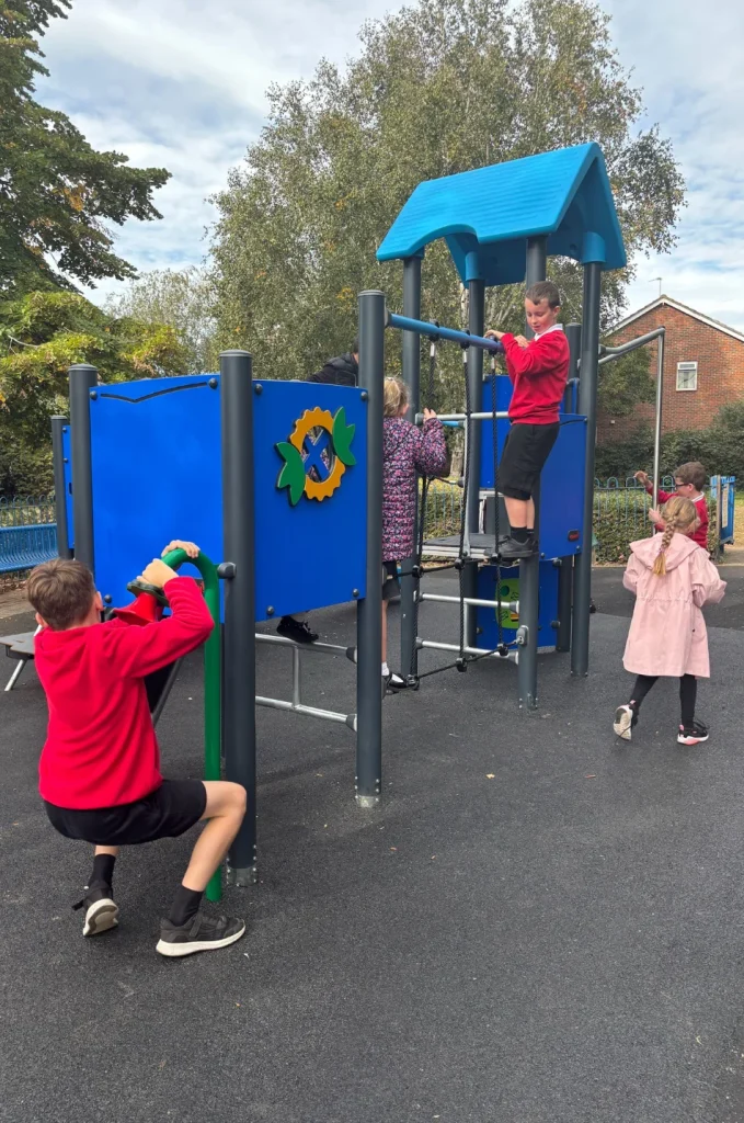 Children play on the blue and grey climbing frame at the refurbished Hilda May Playground in Swanley.